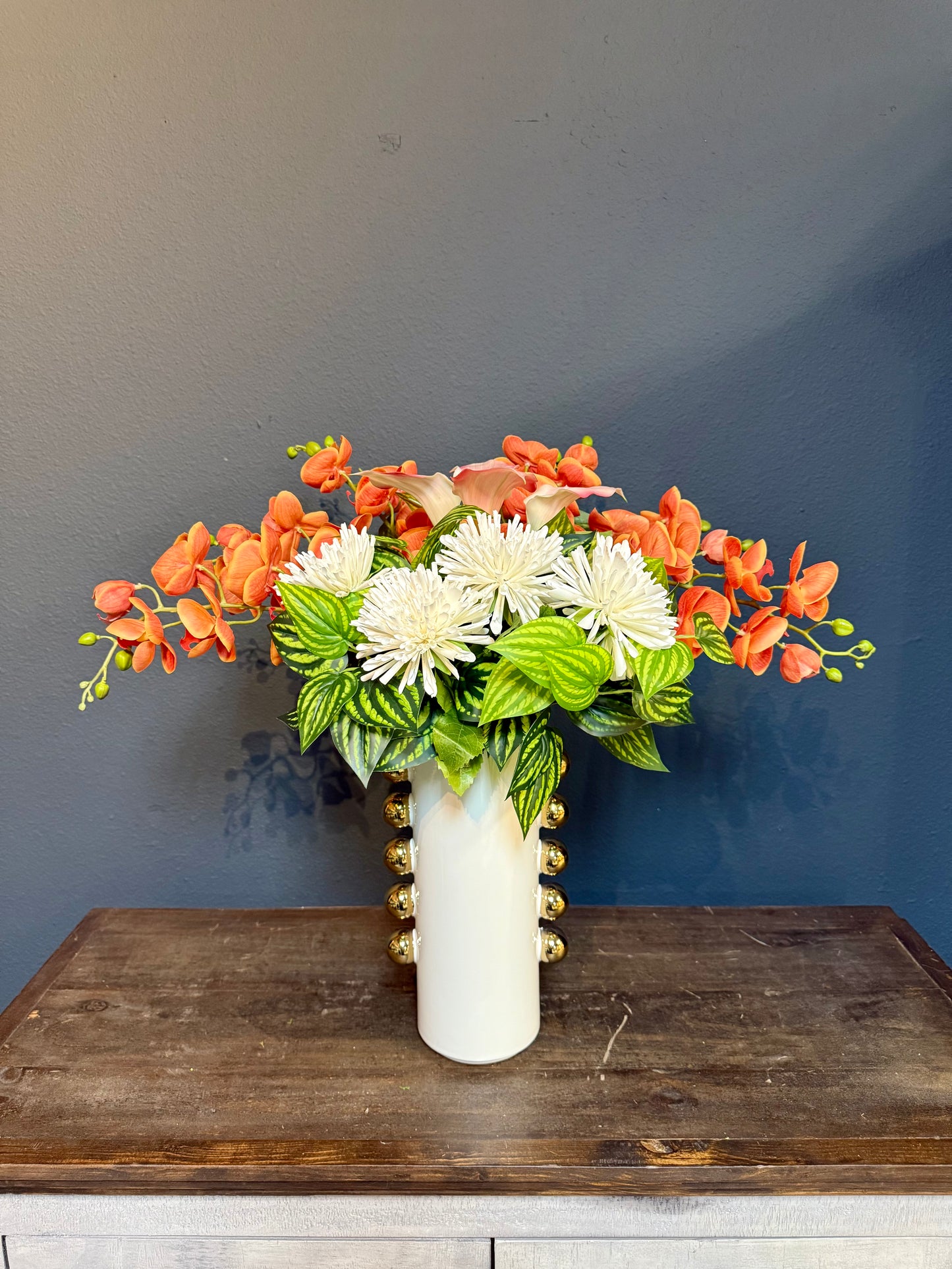 Bright Orange Real Touch Orchids With White Chrysanthemums in a Gold and White Vase